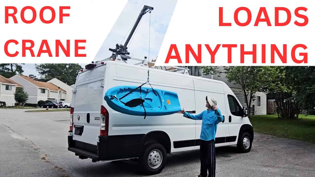 A vehicle-mounted crane lifting a kayak for transport.
